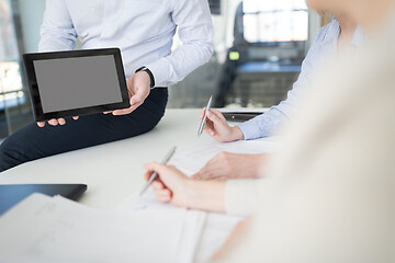 Image showing close up of business team with tablet pc at office