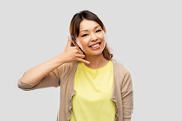 Image showing african asian making phone call gesture