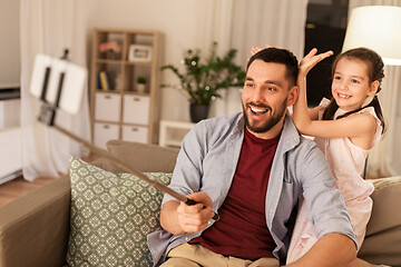 Image showing father and daughter taking selfie at home