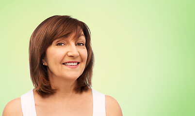 Image showing portrait of smiling senior woman over lime green