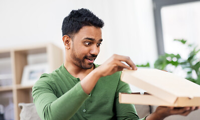 Image showing indian man looking inside of takeaway pizza box