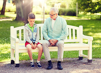 Image showing grandfather and grandson talking at summer park