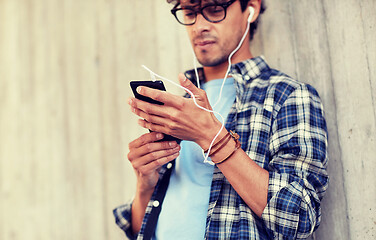 Image showing man with earphones and smartphone listening music