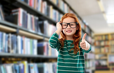 Image showing smiling red haired girl in glasses at library