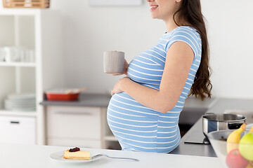 Image showing close up of pregnant woman with cup of tea at home