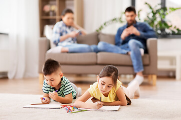 Image showing brother and sister drawing with crayons at home