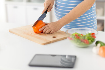 Image showing pregnant woman cooking vegetable salad at home