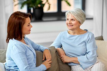 Image showing senior mother talking to adult daughter at home