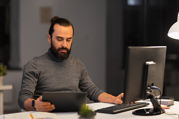 Image showing creative man with computer working at night office