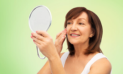 Image showing portrait of smiling senior woman with mirror