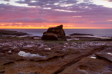 Image showing Coastal sunrise skies on a rocky Sydney reef at low tide