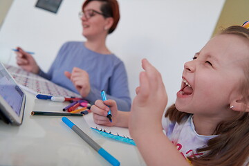 Image showing Mother and little daughter  playing together  drawing creative a