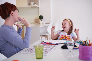 Image showing Mother and little daughter  playing together  drawing creative a