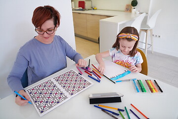 Image showing Mother and little daughter  playing together  drawing creative a