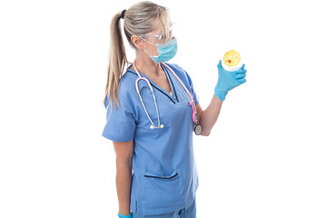 Image showing Laboratory pathologist holding a petri dish with growth cultures