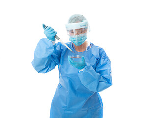 Image showing Laboratory worker or pathologist in full PPE with pipette and pe