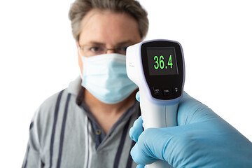 Image showing A man is temperature checked for fever or high temperature 