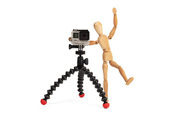 Image showing Wooden dummy standing trying to make a video or photo