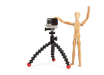 Image showing Wooden dummy standing trying to make a video or photo