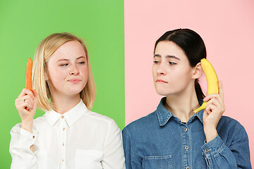 Image showing Beautiful close-up portrait of young women with fruits and vegetables. Healthy food concept.