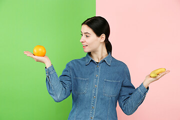 Image showing Beautiful close-up portrait of young woman with fruits. Healthy food concept.