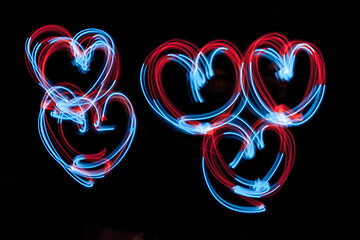 Image showing The hearts - -shaped digital neon lights are on the dark background