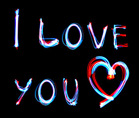 Image showing Glowing inscription LOVE on a black background