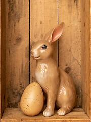 Image showing sweet easter bunny figure with an egg in a wooden box