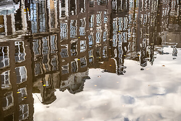 Image showing Beautiful tranquil scene of city of Amsterdam at dusk. Water reflections of traditional houses by the street canal.