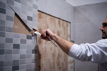 Image showing worker remove demolish old tiles in a bathroom