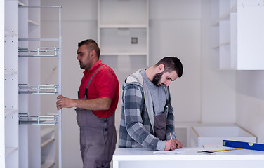 Image showing workers installing a new kitchen