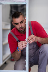 Image showing worker installing a new kitchen