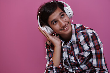 Image showing Arab Teenage Boy Wearing Headphones And Listening To Music