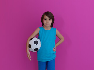 Image showing Arabic boy with soccer ball against  pink background