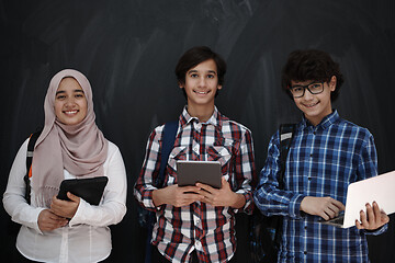 Image showing Arab teenagers group working on laptop and tablet computer
