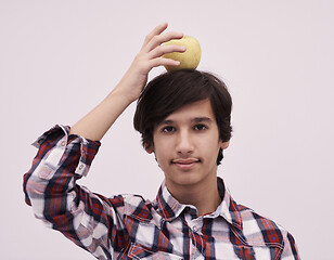 Image showing portrait of a young  teen boy with an apple on his head