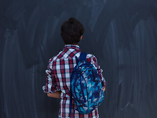 Image showing arab teenager  with schoold backpack against black chalkboard