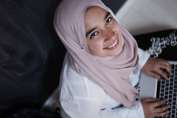 Image showing arab female student working on laptop from home