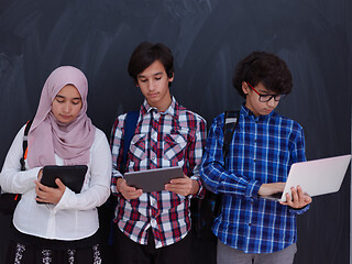 Image showing Arab teenagers group working on laptop and tablet computer