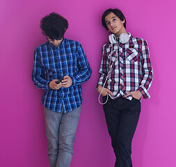 Image showing Arab teenagers  against pink wall