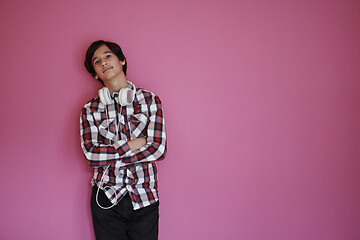 Image showing portrait  of smart looking arab teenager  against pink backgroun