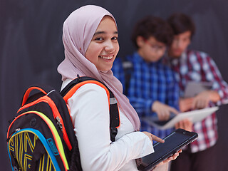 Image showing Arab teenagers group working on laptop and tablet computer