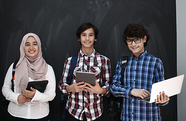 Image showing Arab teenagers group working on laptop and tablet computer