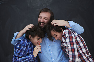 Image showing happy father hugging sons