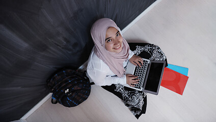 Image showing arab female student working on laptop from home