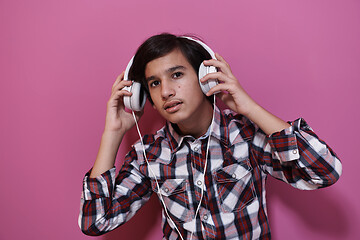 Image showing Arab Teenage Boy Wearing Headphones And Listening To Music