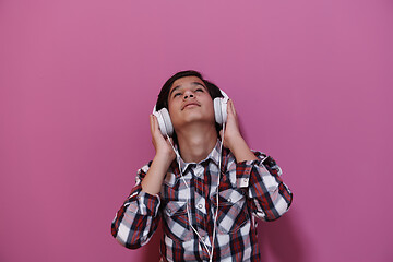 Image showing Arab Teenage Boy Wearing Headphones And Listening To Music