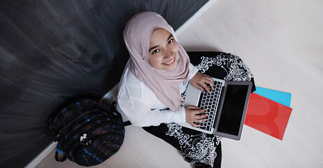 Image showing arab female student working on laptop from home