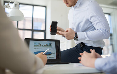 Image showing business team with smartphone working at office