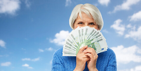 Image showing senior woman with hundreds of euro money banknotes